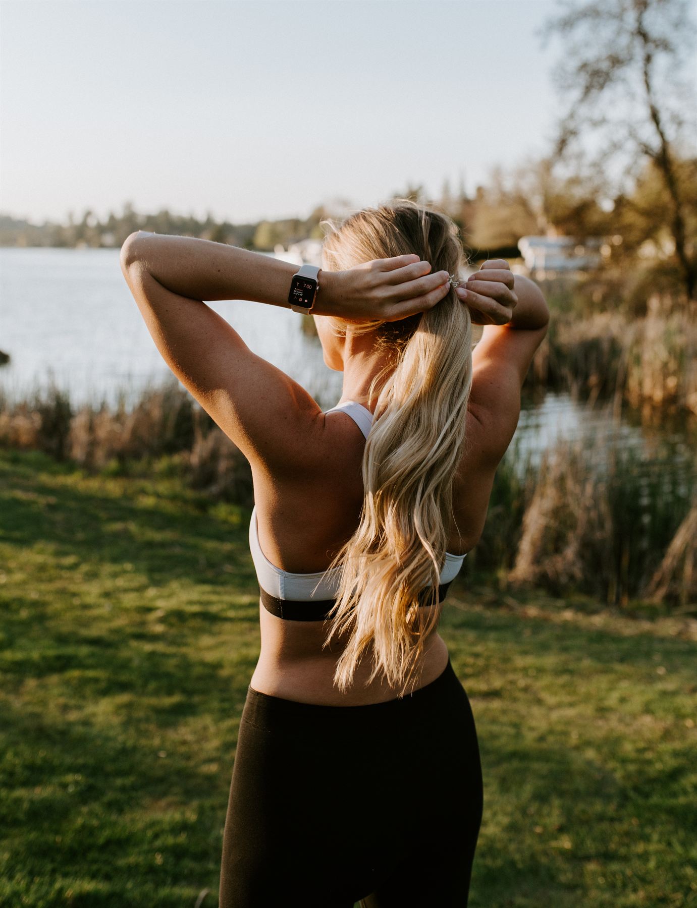 A woman by the lake at golden hour